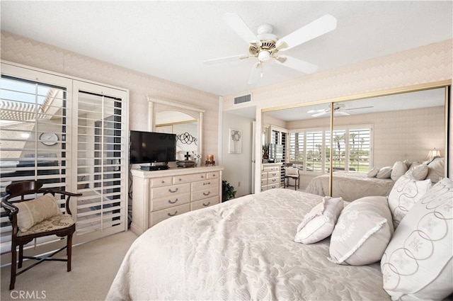 77178 Pauma Valley Way, Palm Desert, CA 92211 - bedroom with wallpapered walls, light colored carpet, and ceiling fan