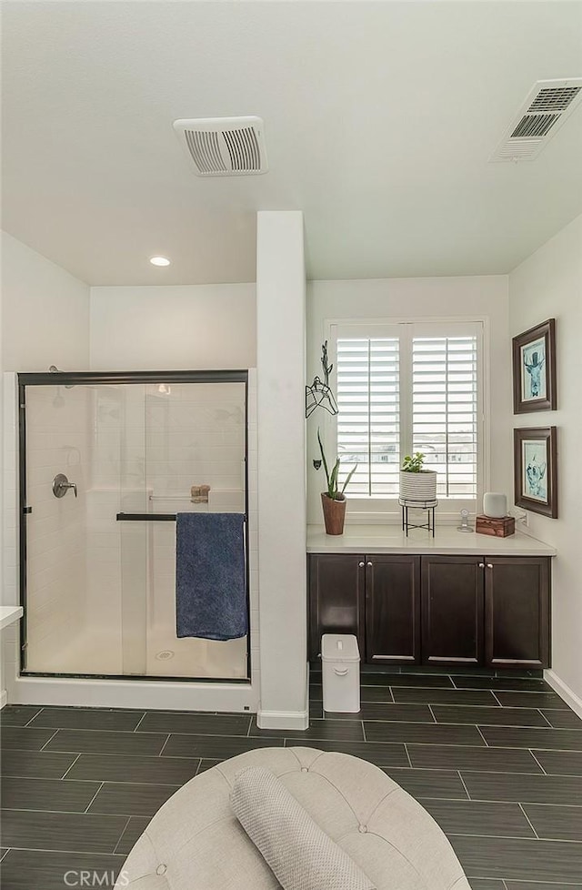 7005 N Astoria Dr, Fresno, CA 93722 - full bath featuring a shower stall, wood tiled floors, baseboards, and recessed lighting