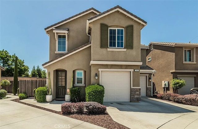 7005 N Astoria Dr, Fresno, CA 93722 - view of front of house with fence, an attached garage, driveway, stucco siding, and a tile roof
