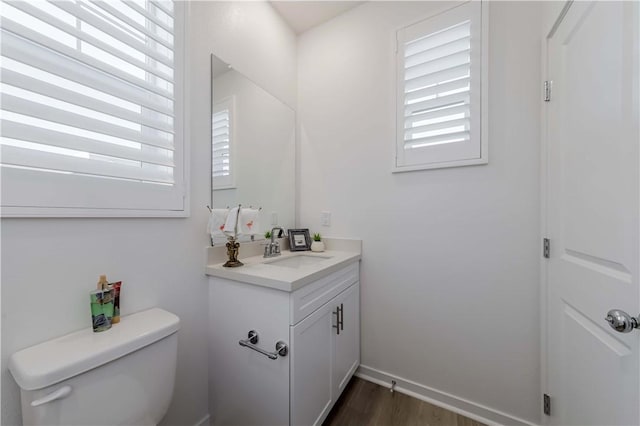 16436 Whittier Blvd Unit 1, Whittier, CA 90603 - half bath with vanity, healthy amount of natural light, toilet, and wood finished floors