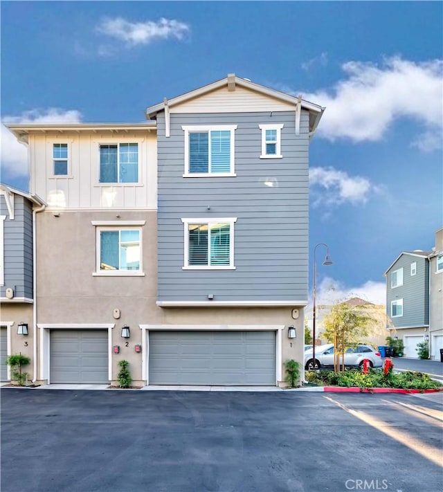 16436 Whittier Blvd Unit 1, Whittier, CA 90603 - view of front of home featuring an attached garage, board and batten siding, and driveway