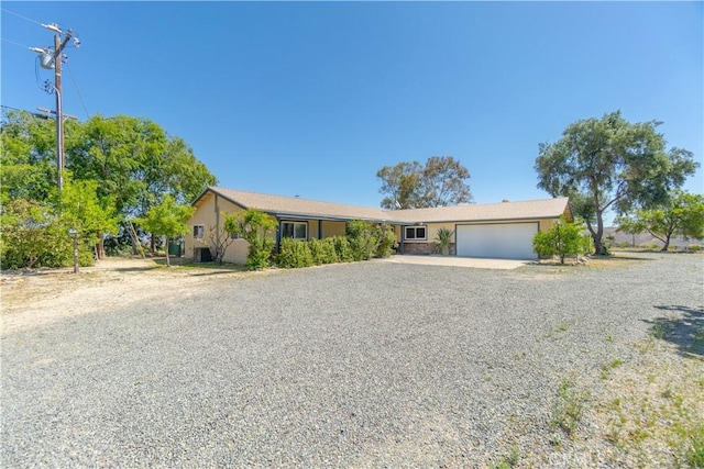 8140 Weirick Rd, Corona, CA 92883 - ranch-style house with an attached garage, gravel driveway, and stucco siding