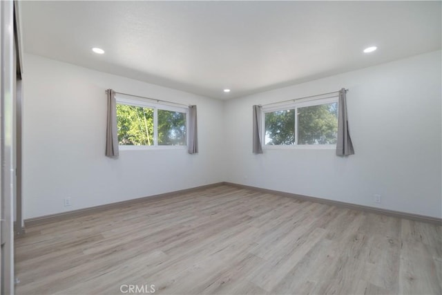 8140 Weirick Rd, Corona, CA 92883 - empty room with plenty of natural light, light wood finished floors, recessed lighting, and baseboards