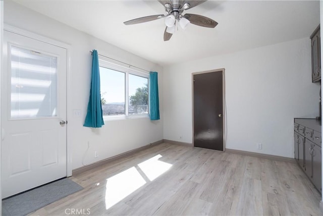8140 Weirick Rd, Corona, CA 92883 - foyer entrance with light wood finished floors, a ceiling fan, and baseboards