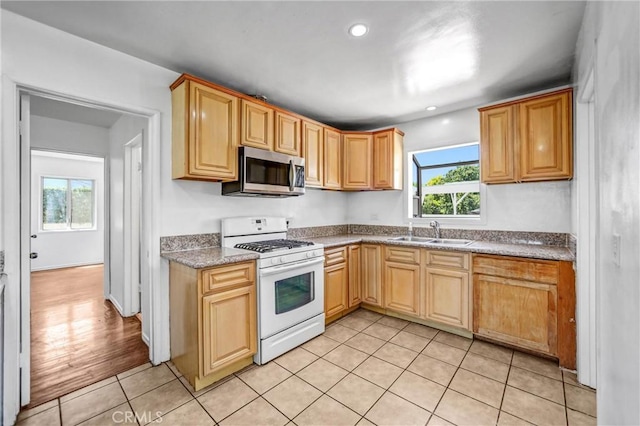 6225 Langdon Ave, Van Nuys, CA 91411 - kitchen featuring white gas range oven, stainless steel microwave, a sink, plenty of natural light, and recessed lighting