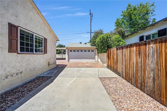 6225 Langdon Ave, Van Nuys, CA 91411 - view of patio / terrace with an outbuilding, fence, and a detached garage