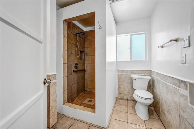 6225 Langdon Ave, Van Nuys, CA 91411 - bathroom featuring tiled shower, toilet, tile patterned flooring, a wainscoted wall, and tile walls