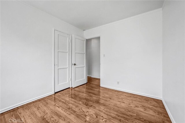6225 Langdon Ave, Van Nuys, CA 91411 - unfurnished bedroom featuring wood finished floors, baseboards, and crown molding
