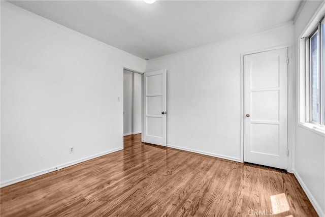 6225 Langdon Ave, Van Nuys, CA 91411 - unfurnished bedroom with wood finished floors, multiple windows, and baseboards