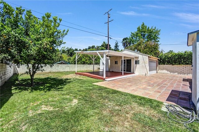 6225 Langdon Ave, Van Nuys, CA 91411 - view of yard with a garage and a patio