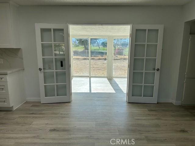 42815 Warner Trl, Palm Desert, CA 92211 - entryway featuring light wood-type flooring, baseboards, and french doors