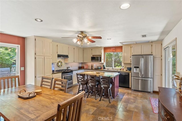 3123 Michael Way, Chico, CA 95973 - kitchen with stainless steel appliances, under cabinet range hood, recessed lighting, a ceiling fan, and cream cabinetry