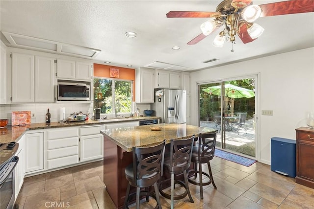3123 Michael Way, Chico, CA 95973 - kitchen with appliances with stainless steel finishes, tasteful backsplash, stone counters, recessed lighting, and white cabinets