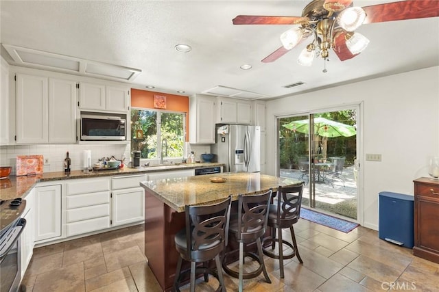 3123 Michael Way, Chico, CA 95973 - kitchen featuring appliances with stainless steel finishes, healthy amount of natural light, decorative backsplash, stone countertops, and recessed lighting