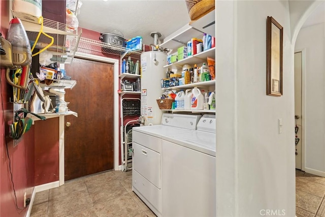 3123 Michael Way, Chico, CA 95973 - laundry area featuring washer and dryer, arched walkways, gas water heater, baseboards, and light tile patterned flooring