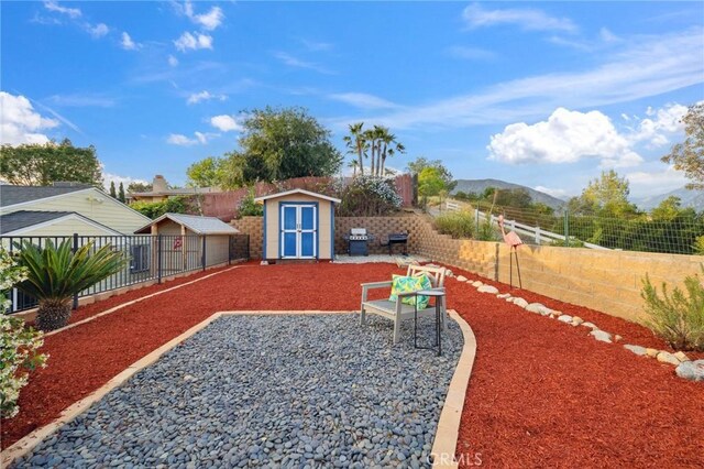 10708 Sable Ave, Sunland, CA 91040 - fenced backyard with a shed, an outbuilding, a patio area, and a mountain view
