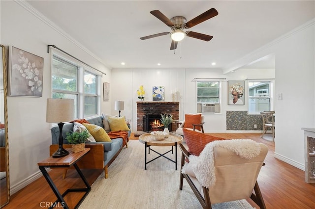 10708 Sable Ave, Sunland, CA 91040 - living room featuring a fireplace, plenty of natural light, light wood finished floors, a ceiling fan, and crown molding