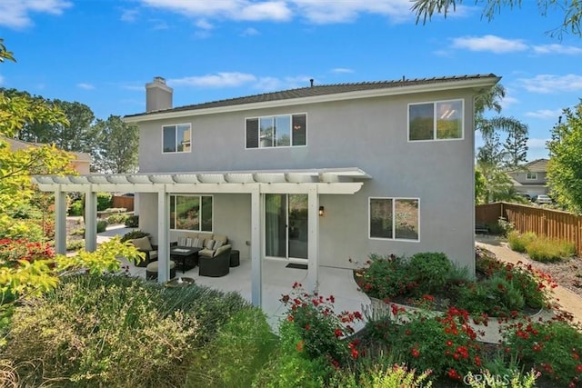 back of property featuring outdoor lounge area, a pergola, fence, stucco siding, and a chimney