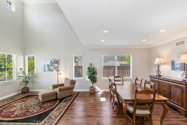 living area featuring plenty of natural light, dark wood-type flooring, baseboards, ornamental molding, and recessed lighting