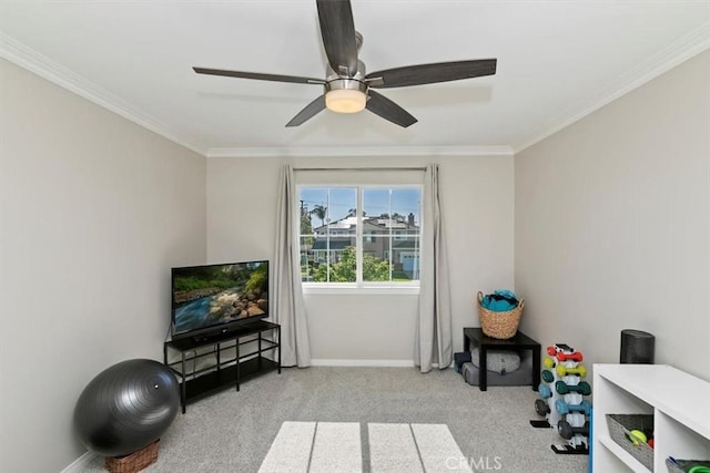 recreation room featuring crown molding, carpet floors, ceiling fan, and baseboards