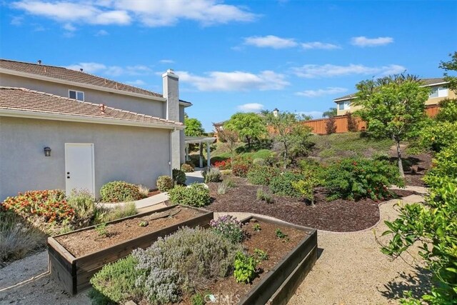 view of yard featuring a vegetable garden and fence