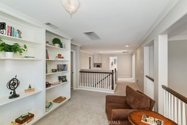 sitting room featuring an upstairs landing, crown molding, and carpet floors