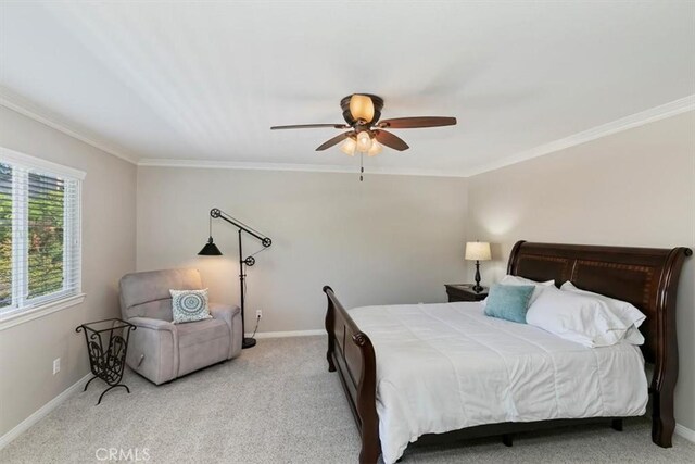 bedroom with crown molding, baseboards, light colored carpet, and ceiling fan