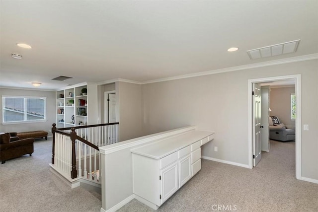 hallway with light colored carpet, healthy amount of natural light, baseboards, crown molding, and recessed lighting