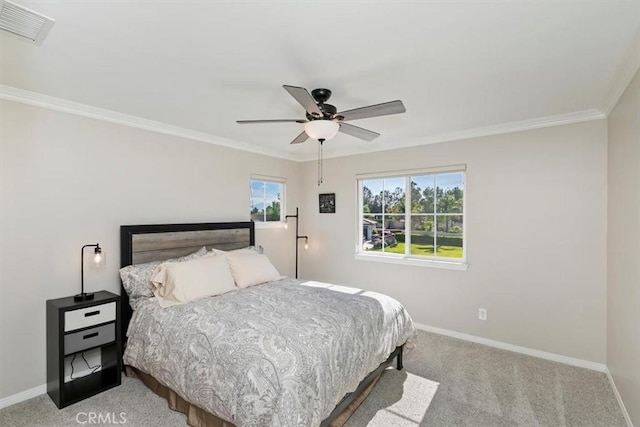 carpeted bedroom with baseboards, multiple windows, crown molding, and a ceiling fan