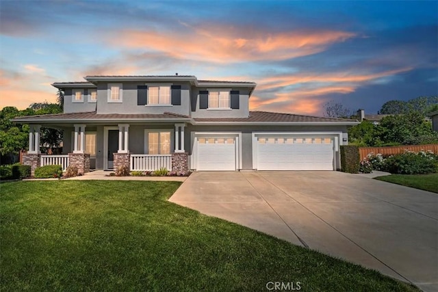 view of front of property featuring driveway, a porch, stucco siding, and a garage