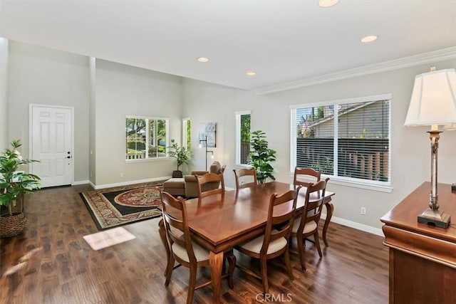 dining space featuring baseboards, dark wood finished floors, recessed lighting, and crown molding