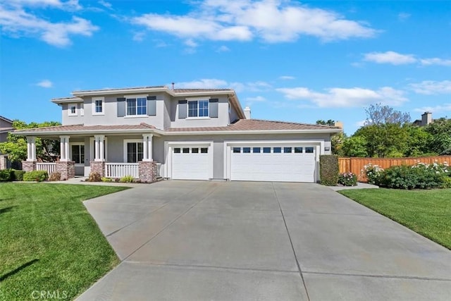 view of front of property with covered porch, stucco siding, driveway, and a garage