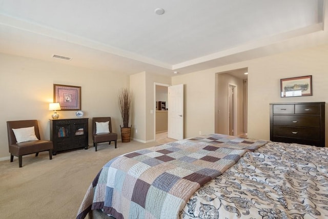bedroom featuring light colored carpet, a tray ceiling, and baseboards