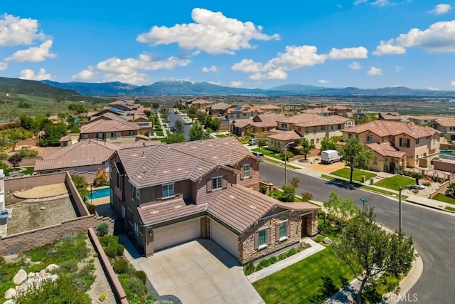 aerial view of residential area featuring mountains
