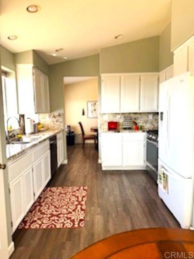 2307 Columbine Dr, Alpine, CA 91901 - kitchen featuring freestanding refrigerator, stainless steel gas stove, a sink, black dishwasher, and tasteful backsplash