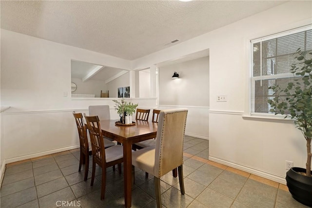 20 Parkhurst St, Chico, CA 95928 - dining area with a textured ceiling, light tile patterned floors, and baseboards