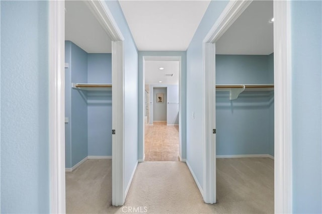 corridor with carpet and baseboards