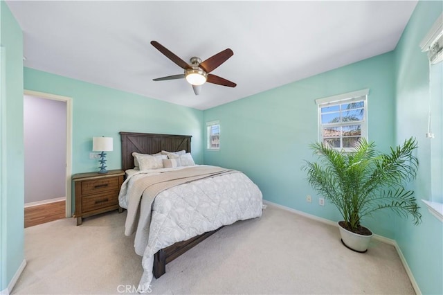 bedroom with carpet, baseboards, and ceiling fan