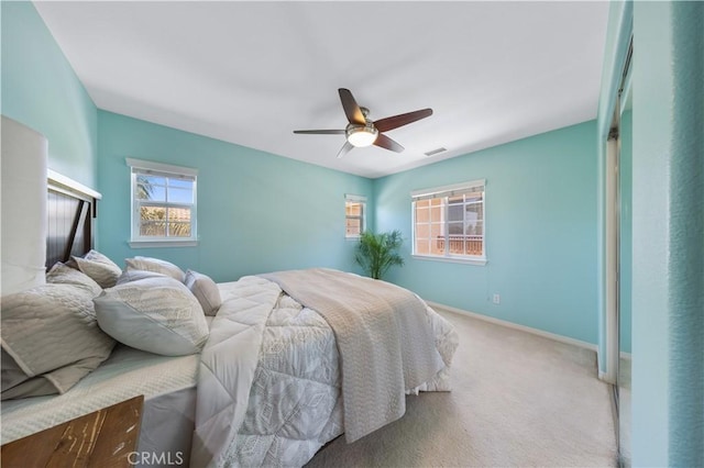 bedroom with carpet, baseboards, and ceiling fan