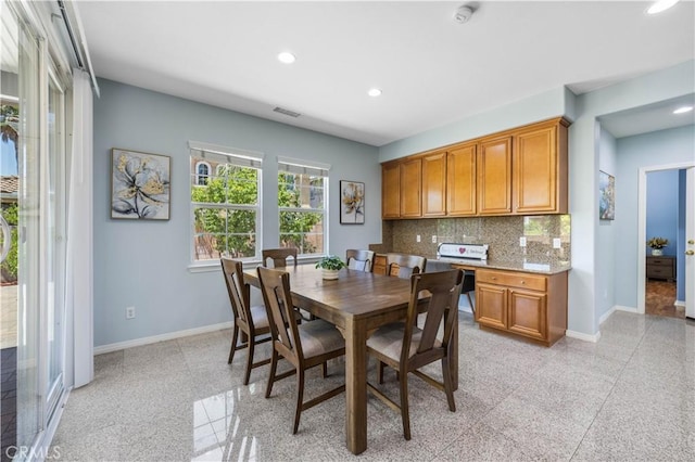 dining room with baseboards, recessed lighting, and granite floors