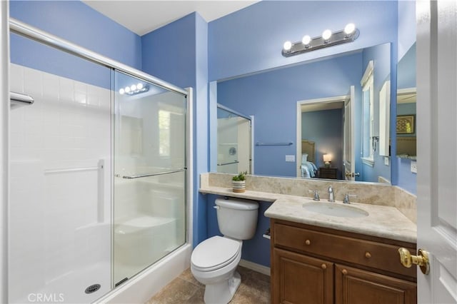 ensuite bathroom featuring a shower stall, toilet, vanity, and tile patterned flooring