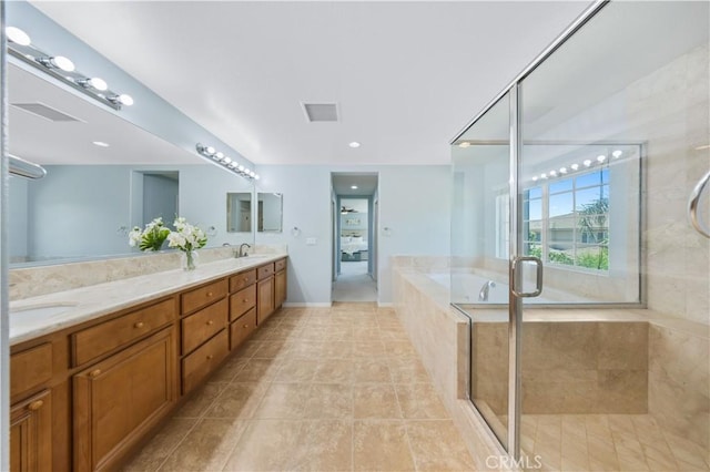 full bath featuring a stall shower, double vanity, a garden tub, tile patterned flooring, and baseboards