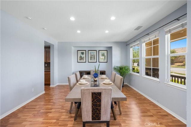 dining space featuring light wood-style flooring, baseboards, and recessed lighting