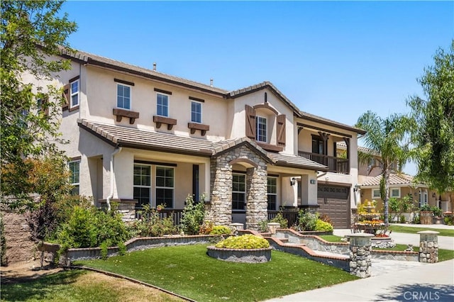 view of front of house featuring stucco siding, a garage, and stone siding