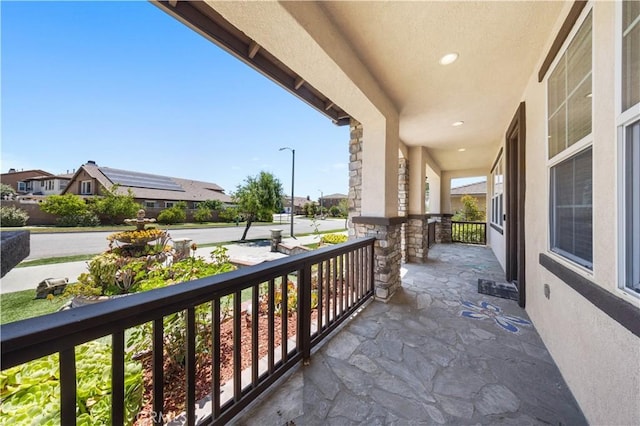 balcony featuring a residential view and covered porch