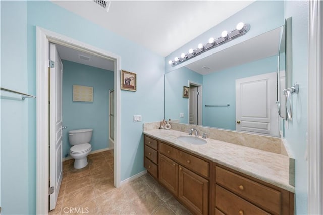 bathroom with toilet, vanity, tile patterned floors, baseboards, and bathtub / shower combination