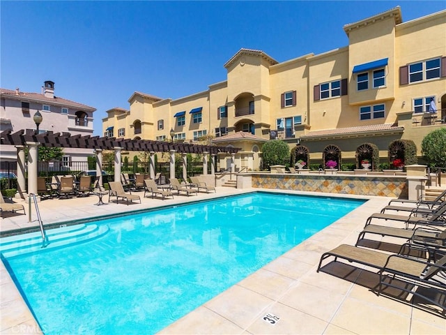 community pool featuring a pergola and a patio area