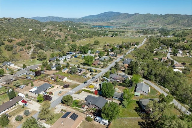 aerial view of property and surrounding area with mountains and nearby suburban area