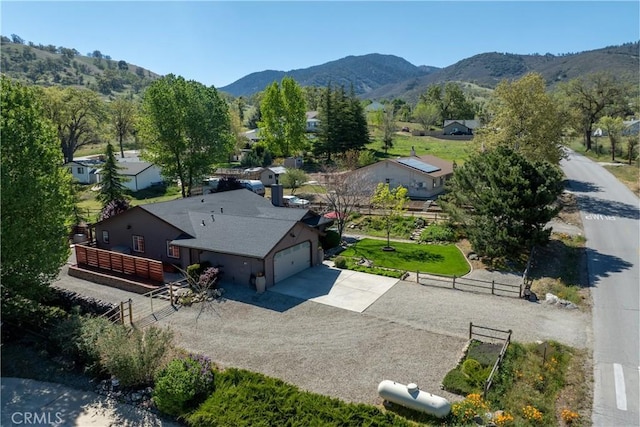aerial view of property and surrounding area with a mountain backdrop
