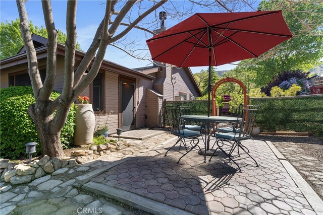 view of patio / terrace featuring outdoor dining space and fence